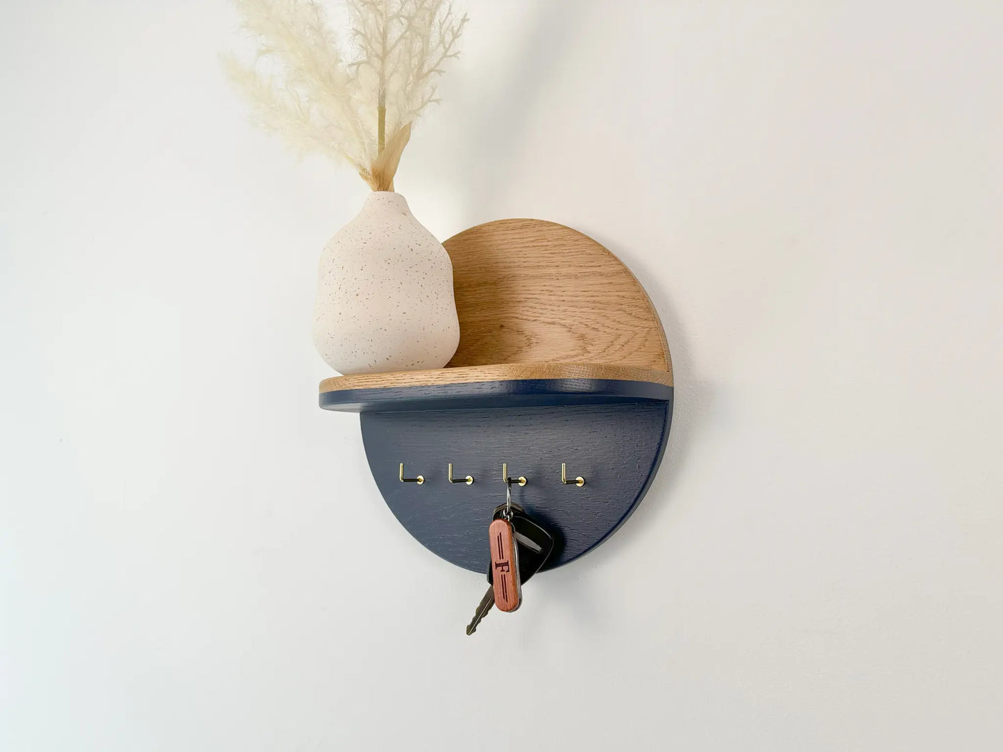 round hey entryway key holder, white oak and navy blue with brass l hooks 