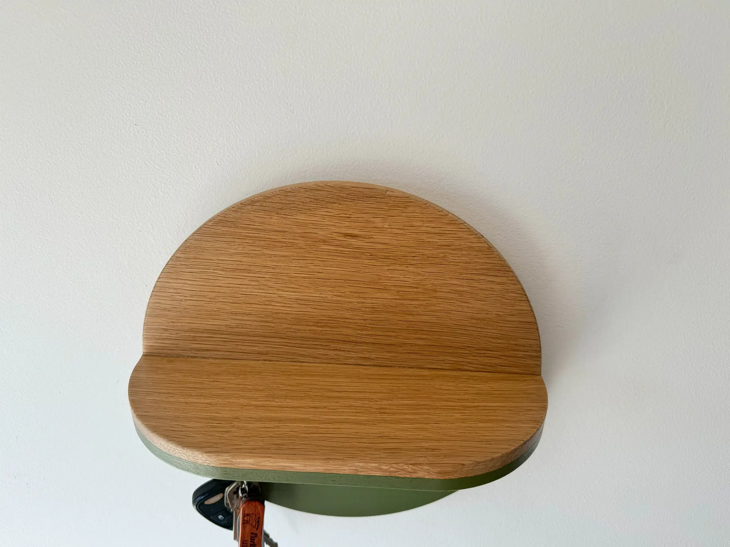 round wall mounted key holder and shelf, top down view 