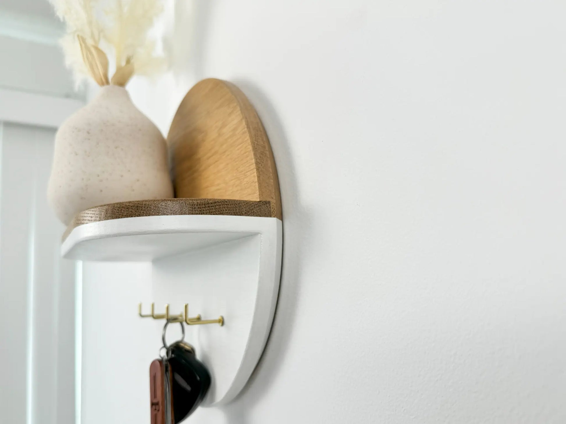 round entryway key holder, flush wall mount, white close up view