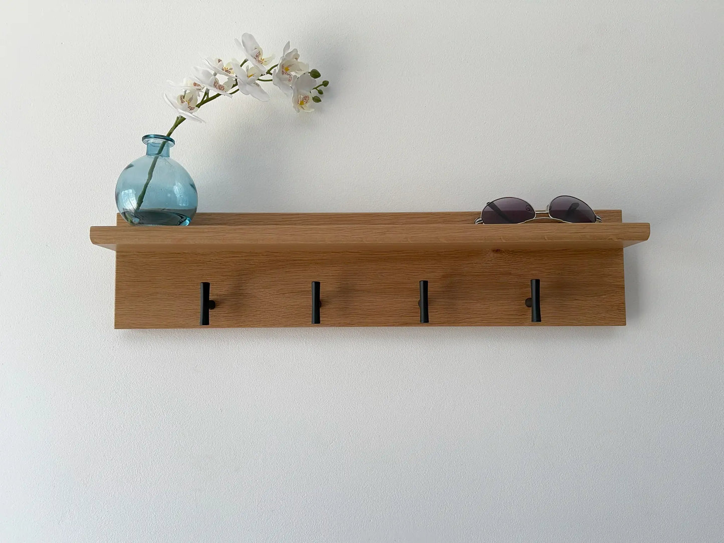 White oak coat rack with shelf, matte black t hooks, front view