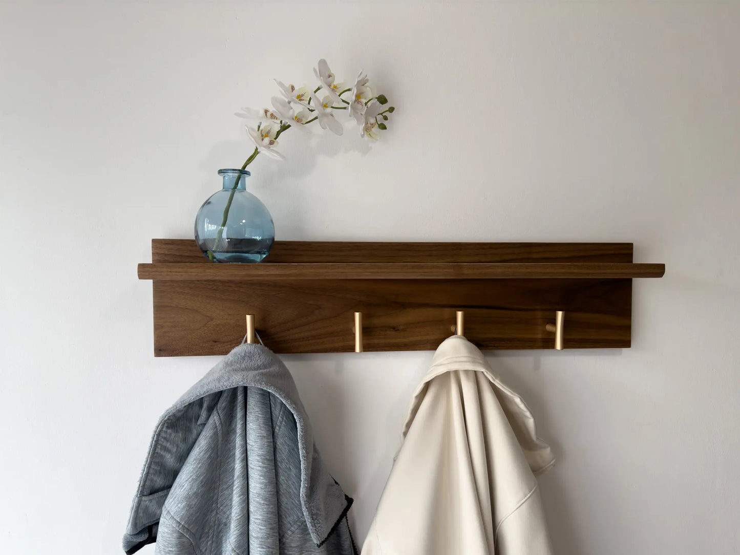 walnut wall mounted coat rack with shelf, champagne t hooks, front view in use  