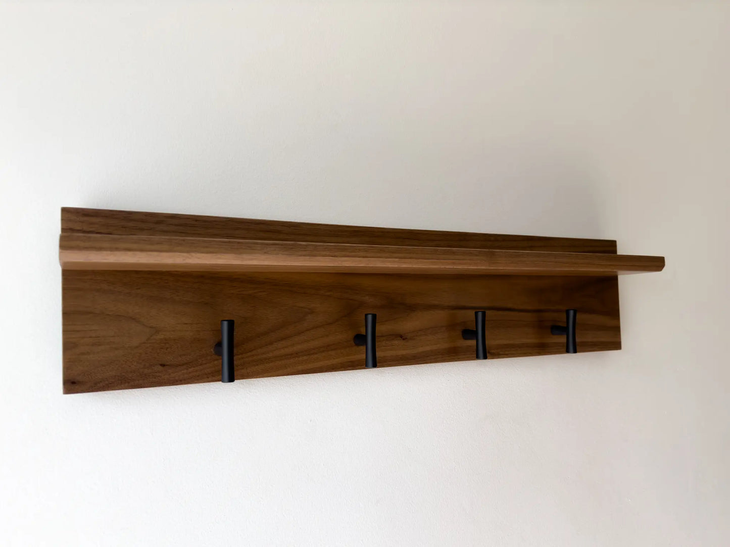 walnut wall mounted coat rack, matte black t hooks, front view 